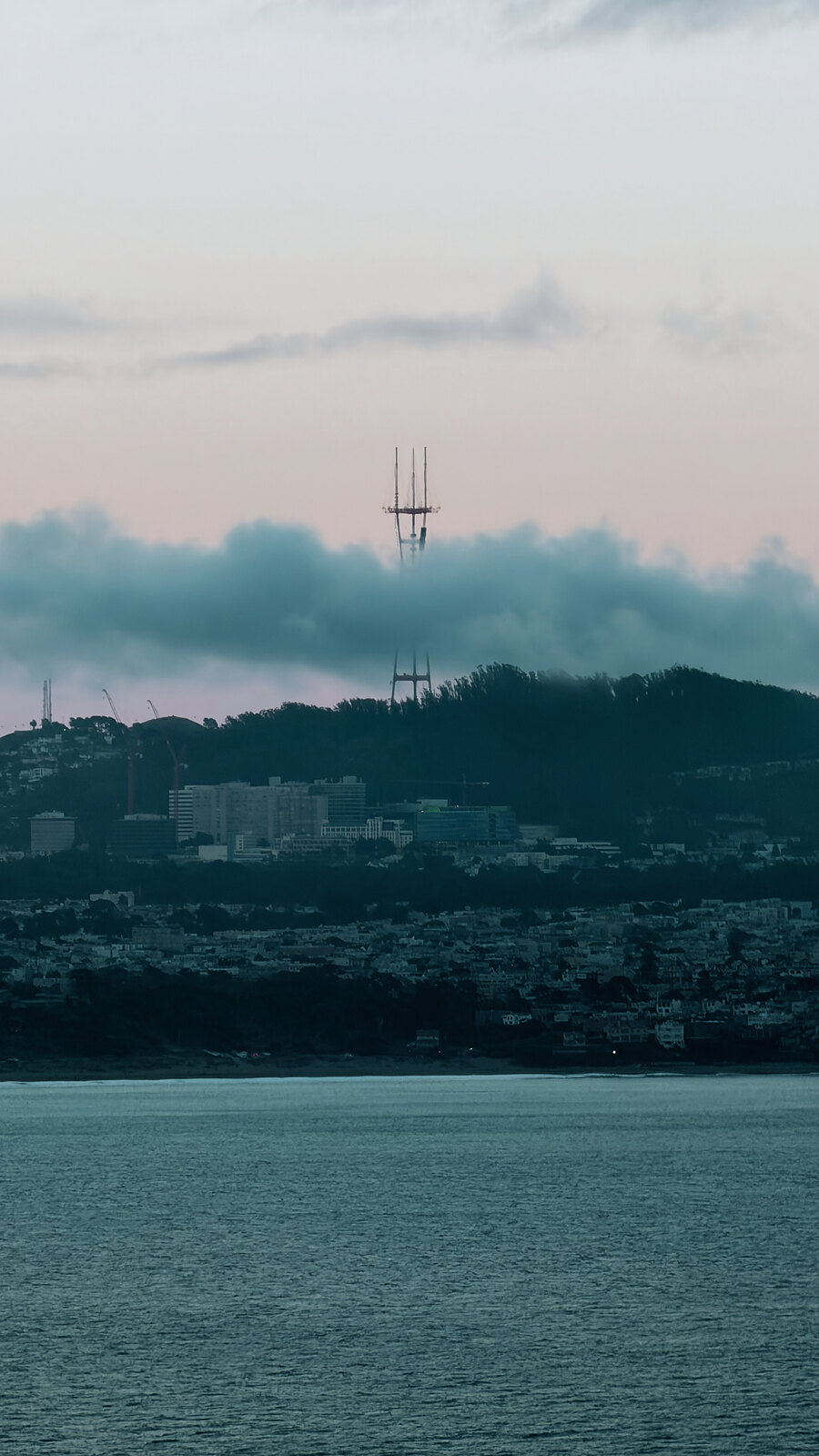 Sutro Tower rising through fog over San Francisco